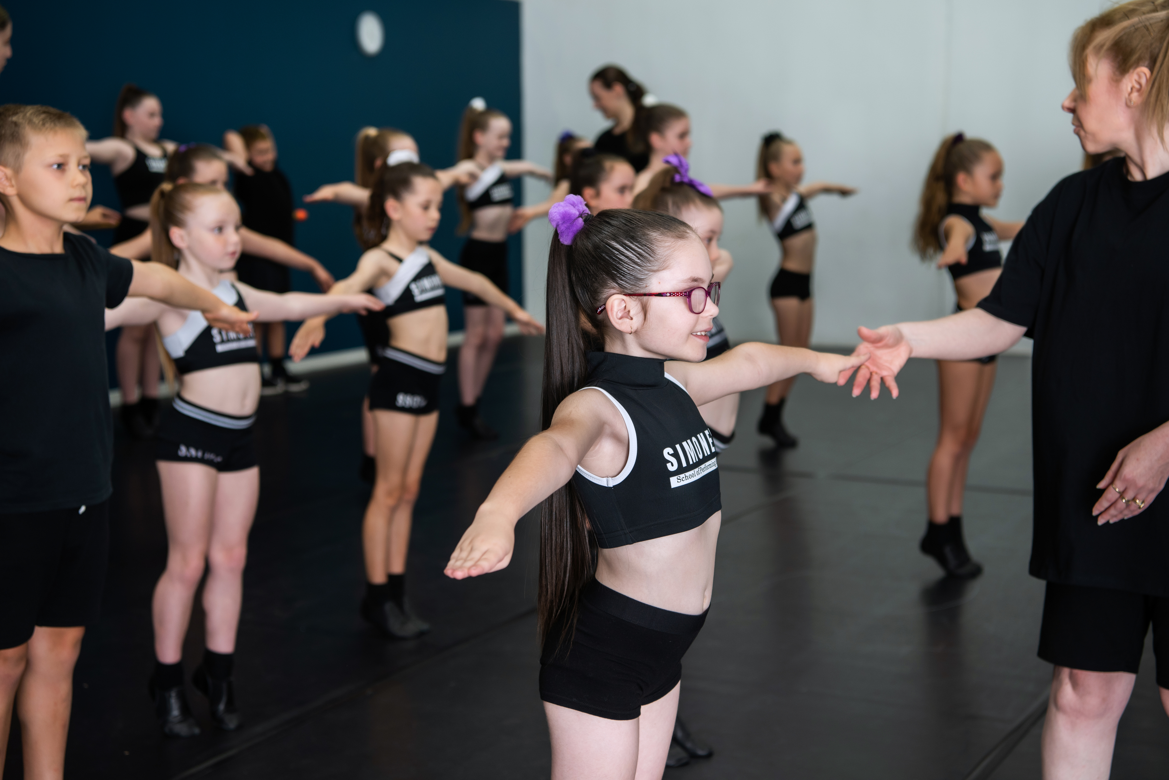 Students participating in a dance class at Simone's School of Performing Arts, illustrating the benefits of dance classes vs. team sports in fostering creativity, discipline, and confidence in children.
