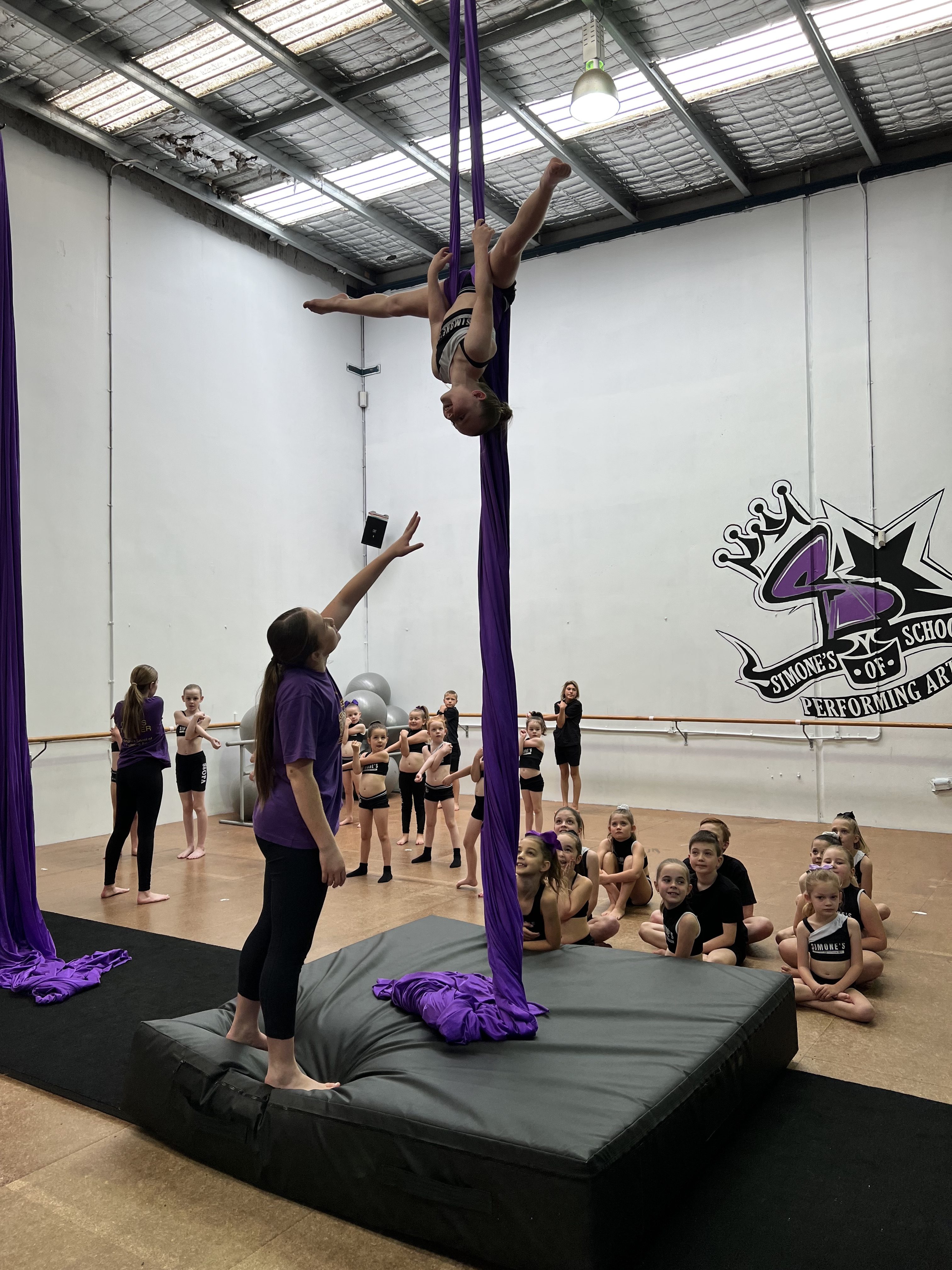 Student being helped by teaching in circus classes on silks at Simone's School of Performing Arts in Berkeley Vale
